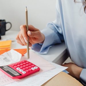 A Woman Computing Bills while Holding a Pencil